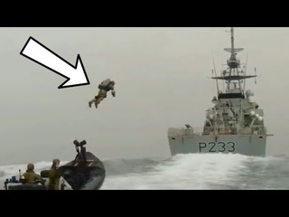 Marines perform boarding exercises with jetpacks and land on a high-speed ship
